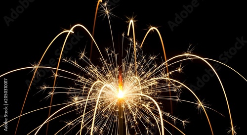 Bright Fireworks Explosion on Black Background with Spark Trails and Glowing Center