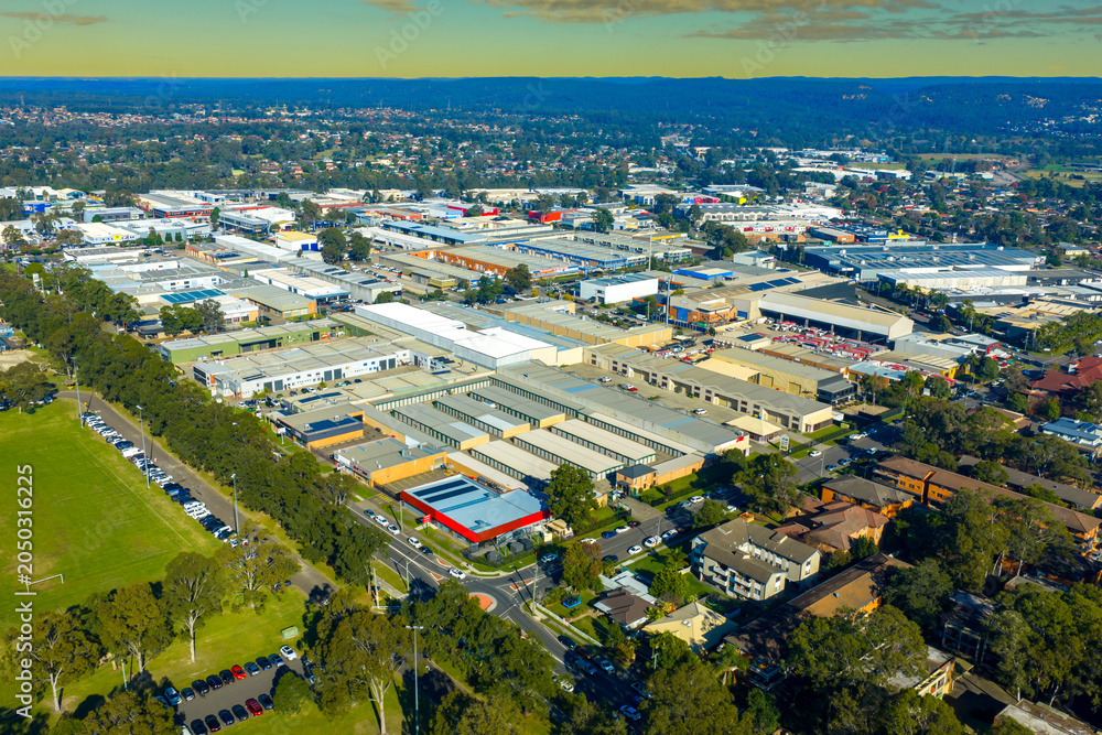 Fototapeta premium Aerial photograph of a large and developing industrial and logistics precinct in the Western Sydney town of Penrith in New South Wales, Australia