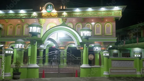 Modern Mosque Exterior Illuminated in Green at Night