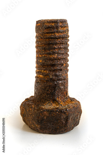 Rusty metal bolt. Mechanical component worn out by time and covered in rust isolated on white background.