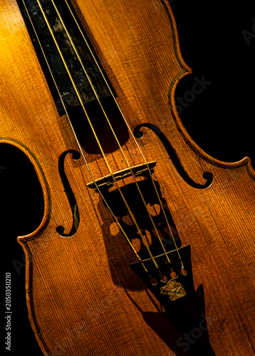 Violin - Close up. Low-key picture of an old-fashioned musical instrument.