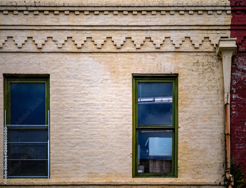 Obraz premium Ornate Brick Work on a Vintage Building with Leaded Glass Windows.