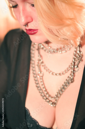 The image captures an elegant woman adorned with multiple stunning necklaces, showcasing a glamorous fashion style and expressing individuality through artistic jewelry choices.