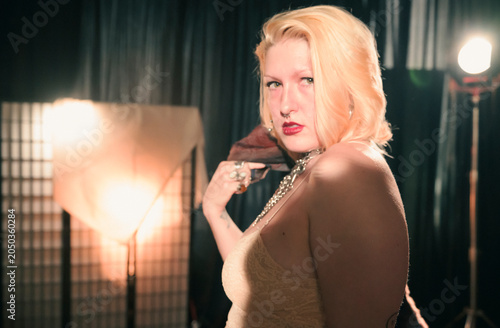 The close-up captures the model's exquisite jewelry and vintage-inspired outfit, emphasizing the beauty of accessories and the allure of fashion photography in an artistic manner.