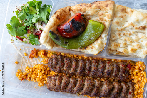 traditional Turkish Adana kebab served with grilled tomatoes and green peppers 
