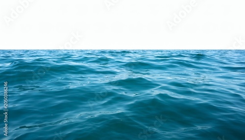 Turquoise Ocean Waves under a Clear Sky: Deep blue and turquoise ocean waves undulate gently under a vast expanse of white sky, suggesting a serene and endless horizon.