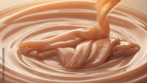 Delicious Caramel Sauce Pouring and Swirling in a Sweet Dessert.