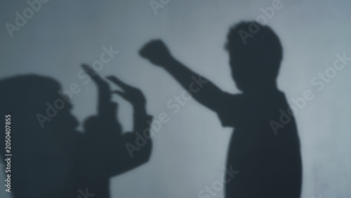 Canvas Print Silhouette of a man raising his fist at a woman