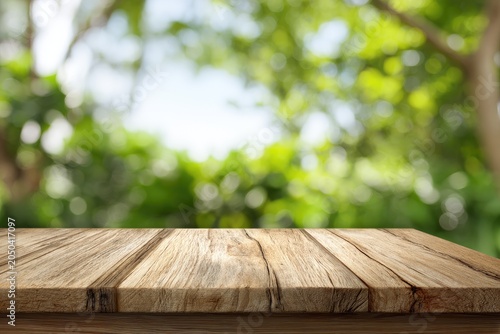 Wood table with blurred green foliage background