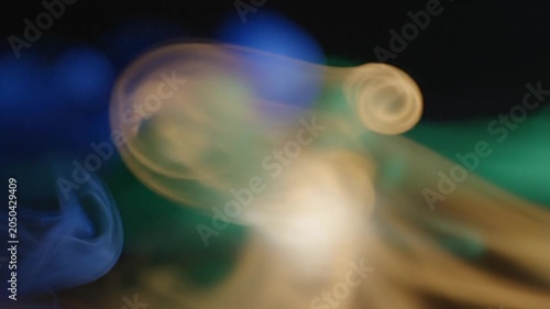 Abstract blue and green blurred colors on dark background