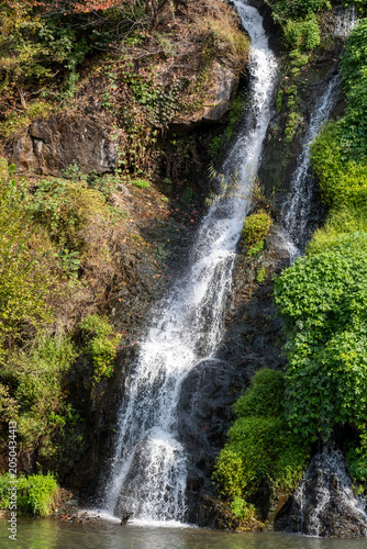 Close-up of waterfall with autumn foliage