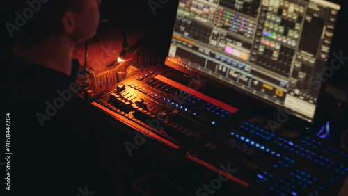 Bild auf Leinwand Lighting engineer operator working on mixing console workplace during live event