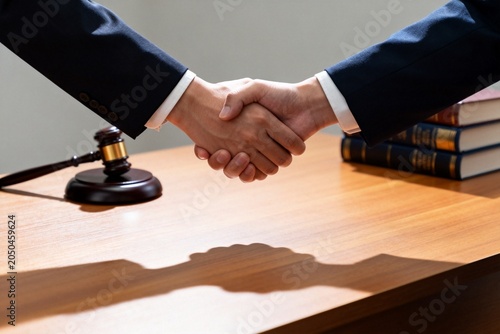 Lawyers Shaking Hands Over Wooden Desk with Gavel