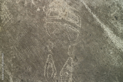 Quadro su tela An abstract ancient petroglyph carving etched into a weathered stone surface dep
