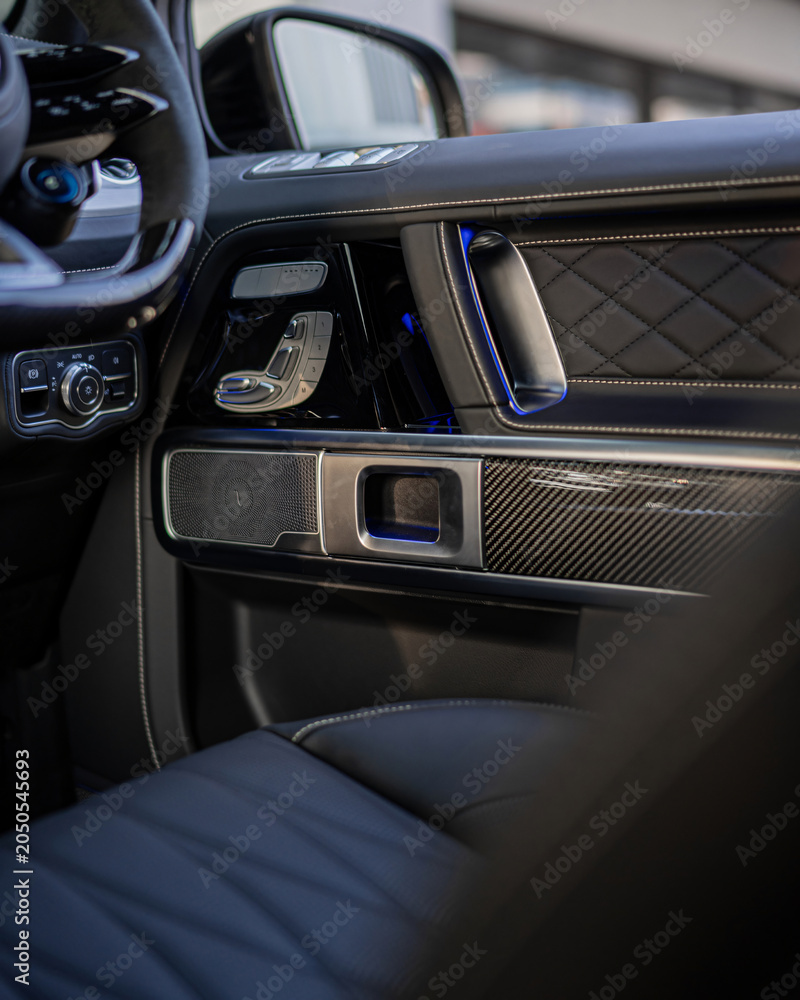 Fototapeta premium Luxurious car interior with leather dashboard ambient lighting.