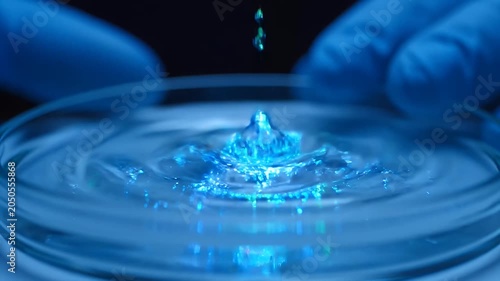 Biotechnology research with glowing liquid in petri dish