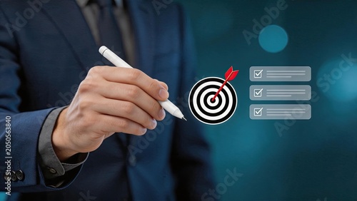 Hand holding pen pointing at target with arrow hitting bullseye, business goal achievement concept, strategic planning checklist with checkmarks for success metrics and objective