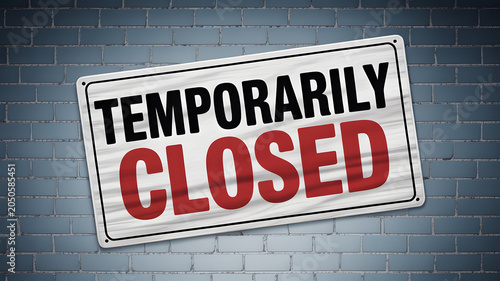 A temporarily closed sign on a brick wall indicating business pause