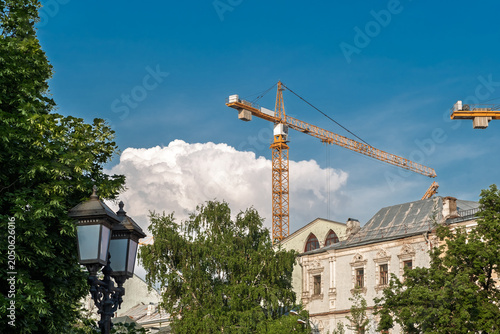 Canvas Print Moscow, Russia - May 13, 2026: Construction crane stands above a historic buildi