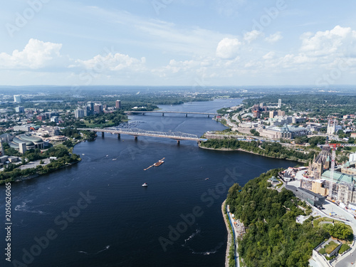 Bild auf Leinwand Drone view of Canadian Parliament, Parliament Hill, House of Commons, and East Block in downtown of Ottawa and river in a sunny day, Canada