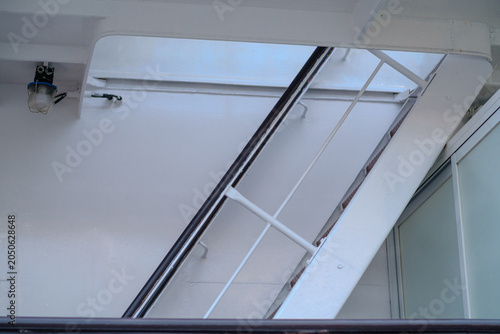 Slika na platnu Staircase features a white metal railing leading to the upper deck of a modern s
