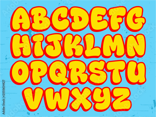 Fotografie Round bubble alphabet letters in yellow and red on blue textured background playful font