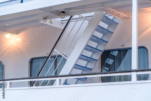 Quadro su tela Staircase leading to upper deck on a cruise ship, with blue steps and illuminate