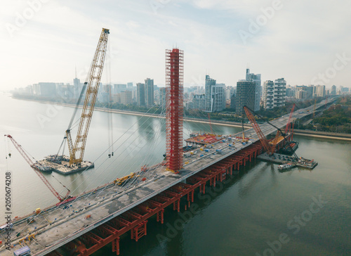 Foto Aerial view of cranes and construction equipment are working to dismantle an old cable stayed bridge
