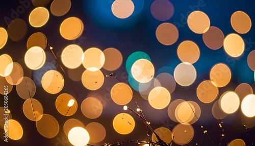 Golden bokeh lights in dark background.