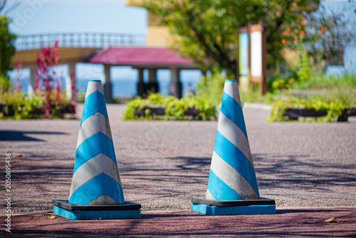 Blue and white traffic cones on wooden deck in Japan