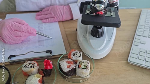 Food safety inspection on sushi in laboratory with microscope and notes in a health review