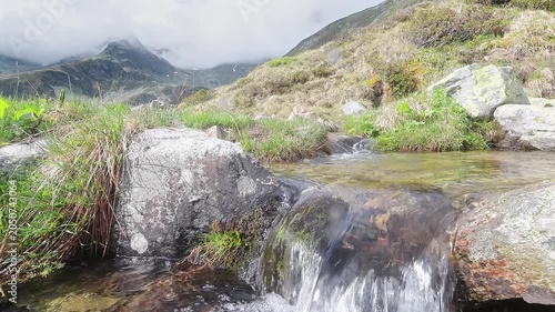 Waterfall with Suretta massif on background, Montespluga landscape