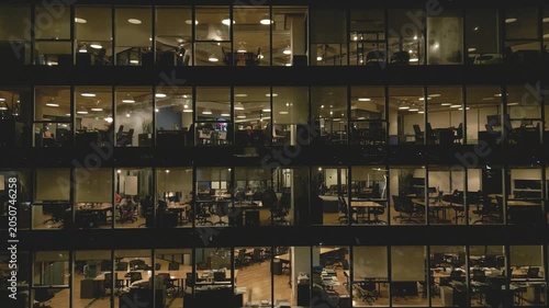 Workers finish tasks late at night in an office building in downtown