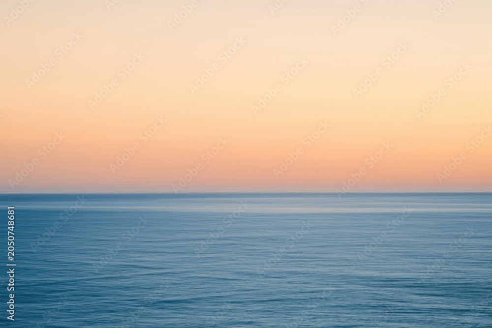 Fototapeta premium The Ocean at Sunrise with Soft Pastel Sky and Calm Serene Horizon