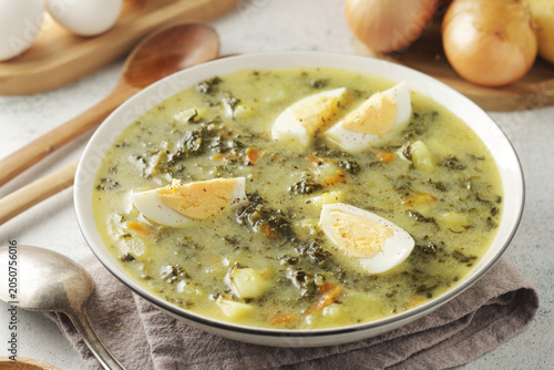 A bowl with traditional Polish sorrel soup Zupa Szczawiowa	