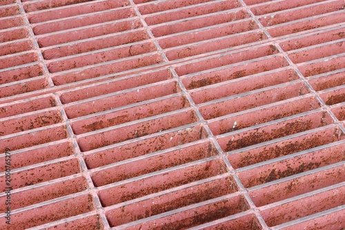 Old and rusty red steel grate perspective background
