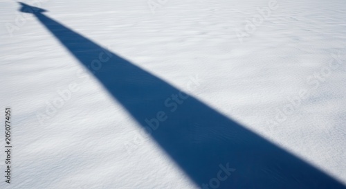Long Blue Shadow Across a Vast Snow Field