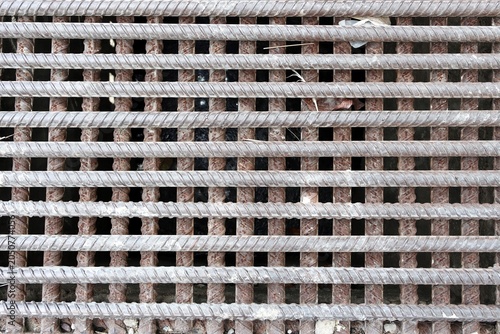 Old and rusty deformed steel bars grate pattern background