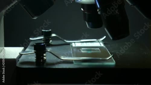 Microscope Objective Examining Sample on Glass Slide in Medical Laboratory