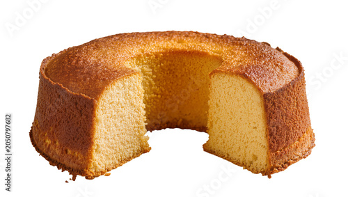 Konstfotografi Golden brown ring cake with a slice removed showing fluffy texture