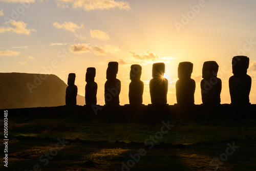 Majestic and peaceful sunrise silhouette of moai statue on easter island chile