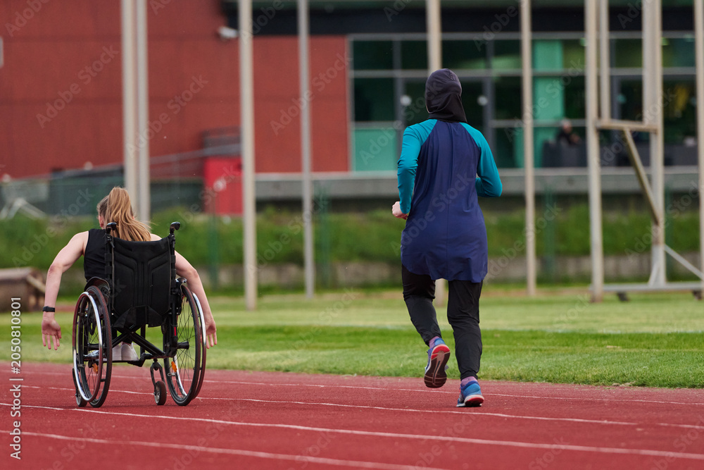 Fototapeta premium Athlete in Wheelchair Racing on Track Beside Female Runner Promoting Inclusive Fitness and Determination