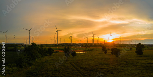 Landscape panorama of Many wind turbine at the fields at sunset