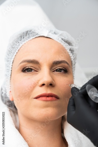 Woman receiving cosmetic treatment in a modern clinic setting