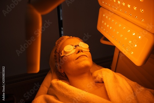 Woman undergoing skin therapy with light treatment in a spa setting