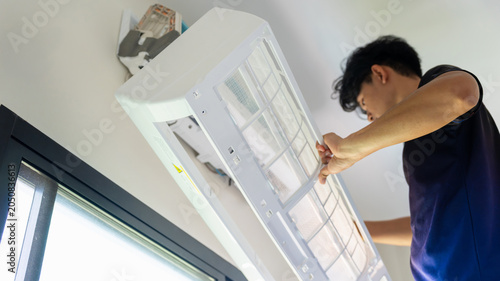 Εκτύπωση καμβά Repairman cleaning air conditioner filters in modern home, Maintenance service w
