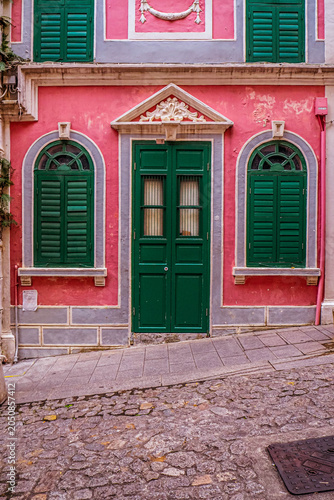 Vibrant Portuguese Colonial Architecture with Green Wooden Shutters