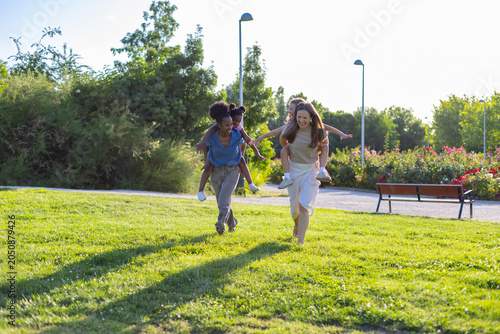 Εκτύπωση καμβά Diverse mothers giving piggyback rides to happy daughters