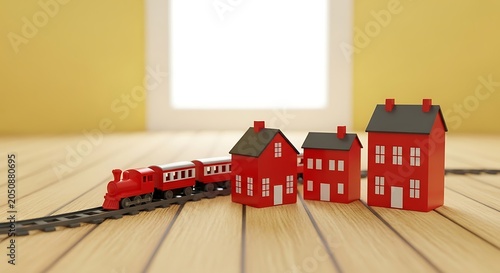 Red toy train with miniature houses on wooden floor in bright room