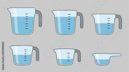 Modern kitchen elements set featuring glass measuring cups with different liquid levels for baking and cooking